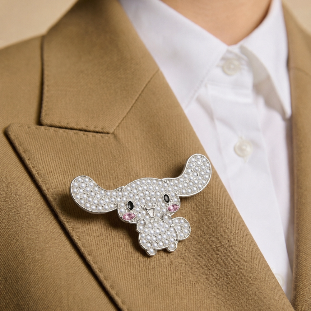 Person wearing a brown blazer with a decorative cinnamoroll brooch, and white shirt underneath.