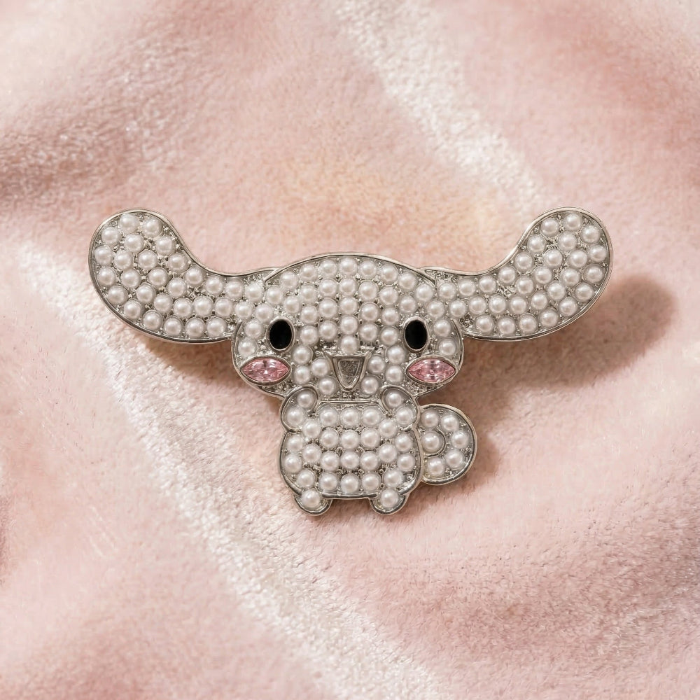 Pearl Cinnamoroll brooch on a pink textured background