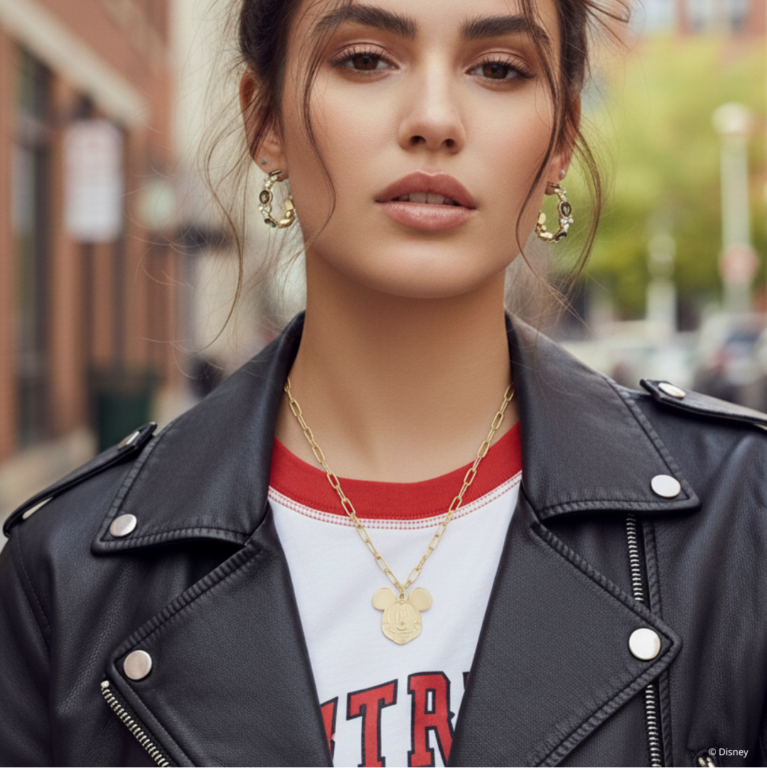 Model wearing yellow gold plated, Mickey Mouse ace pendant with paperclip chain, by couture kingdom.